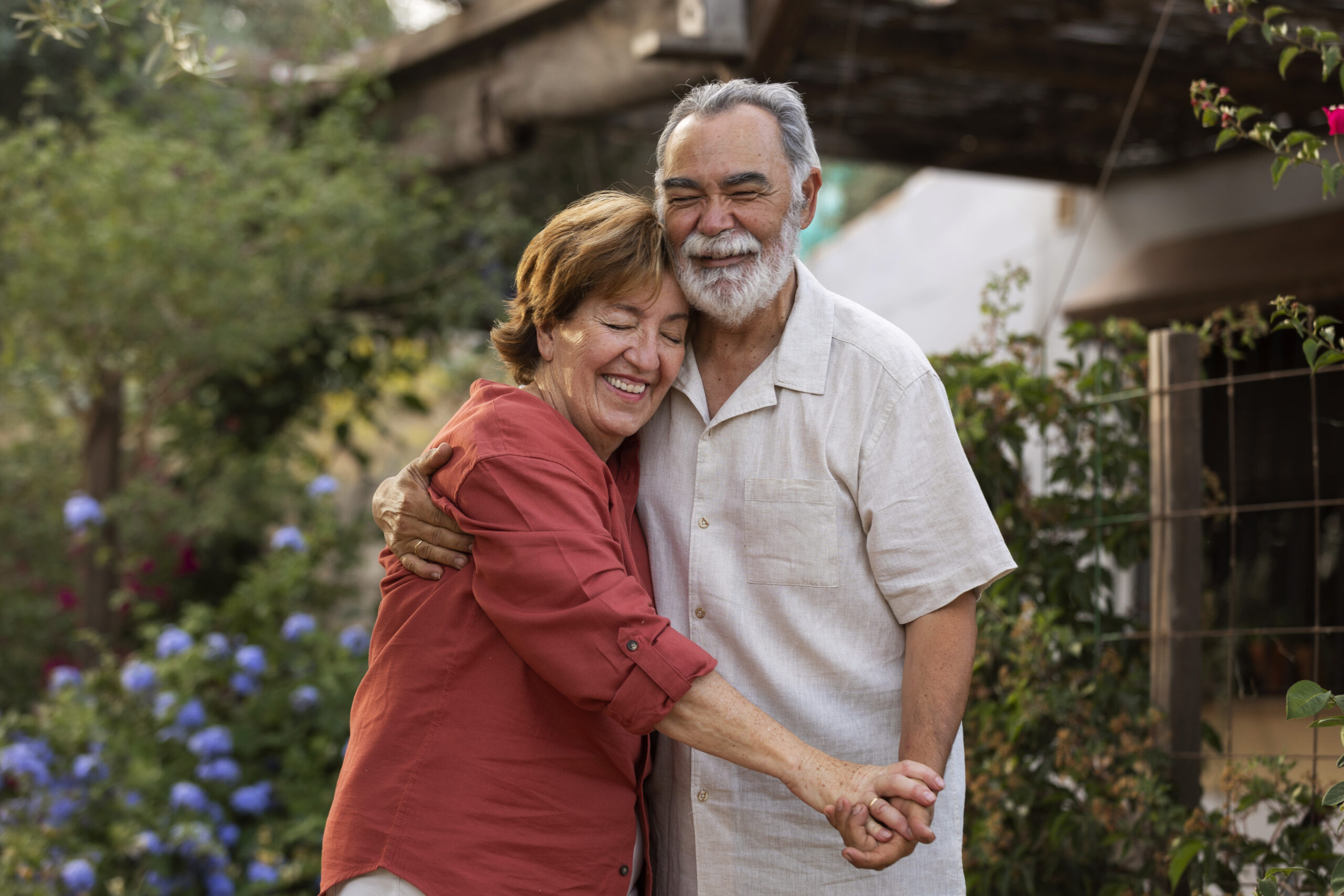 elderly-couple-holding-each-other-romantically-their-countryside-home-garden